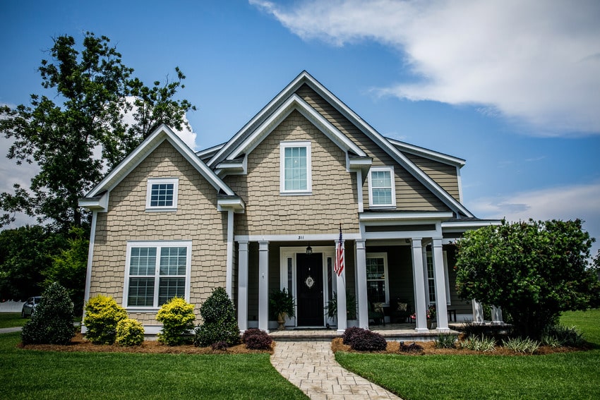 Colonial styled house that has brick siding 