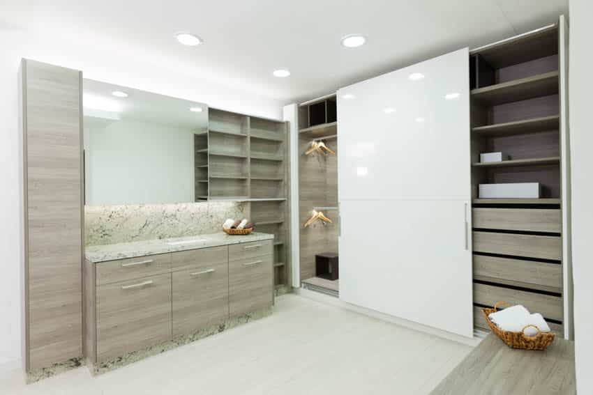 Closet with sliding door wood drawer flooring and mirror