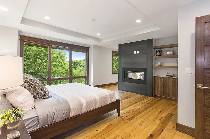 Contemporary bedroom with platform bed fireplace hardwood floors