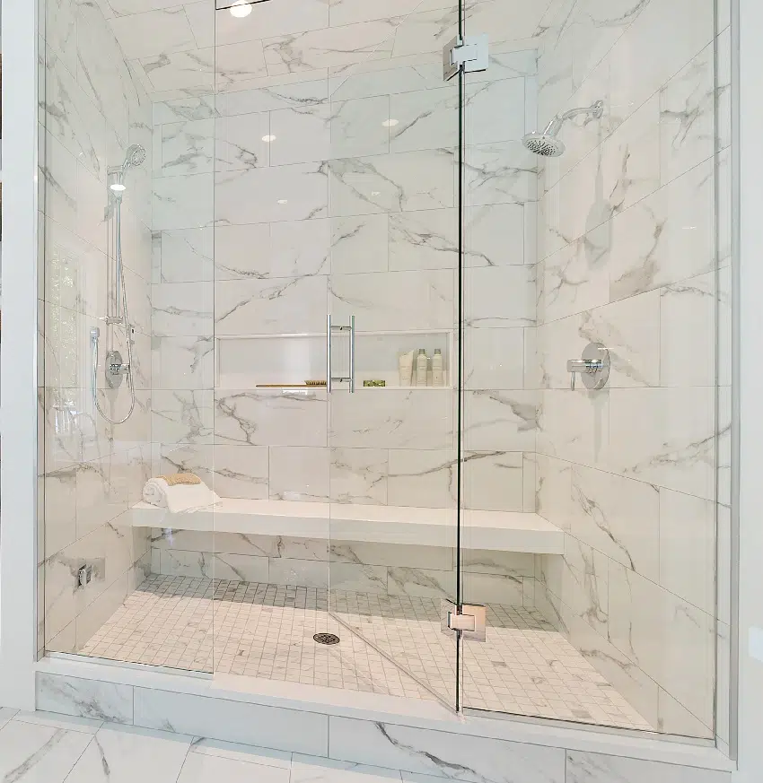 decorative tile with long floating bench and glass stall in shower