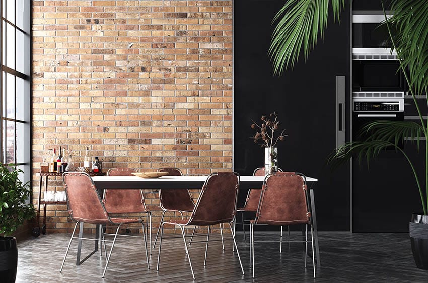 Dining room with stained brick wall large wall of windows