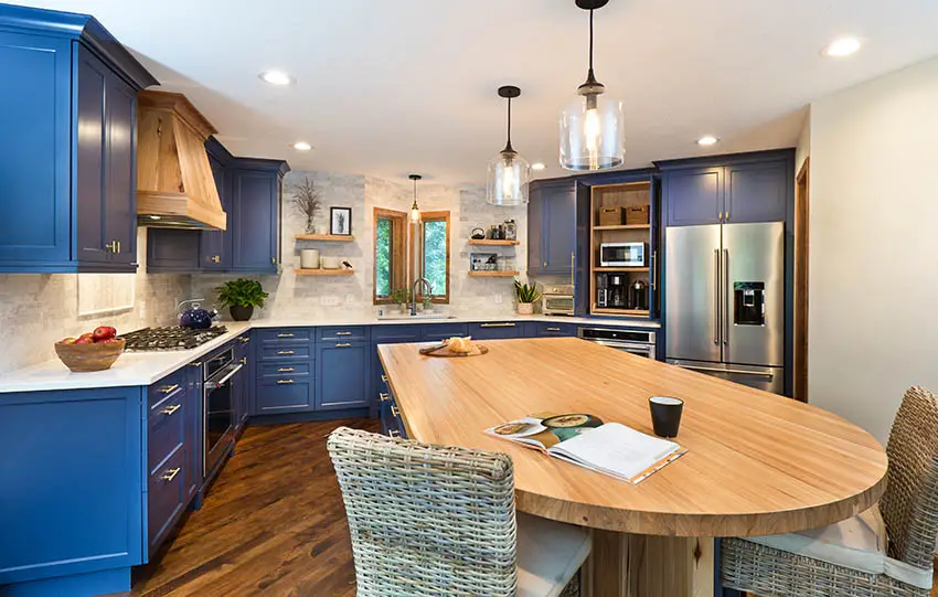 Kitchen with edge grain butcher block wood countertop island quartz counters blue cabinets