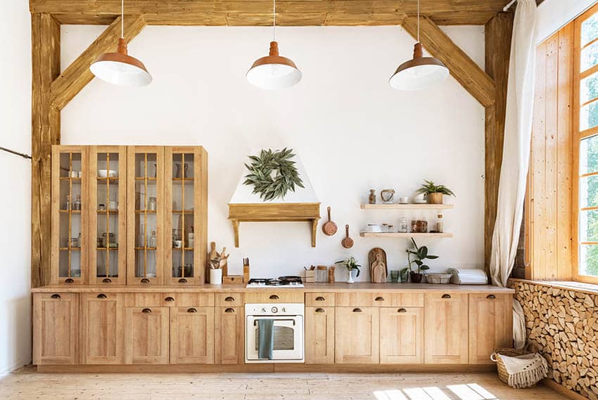 Kitchen with oak cabinets white painted walls high ceiling