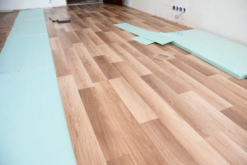 Laminate flooring with attached underlayment construction