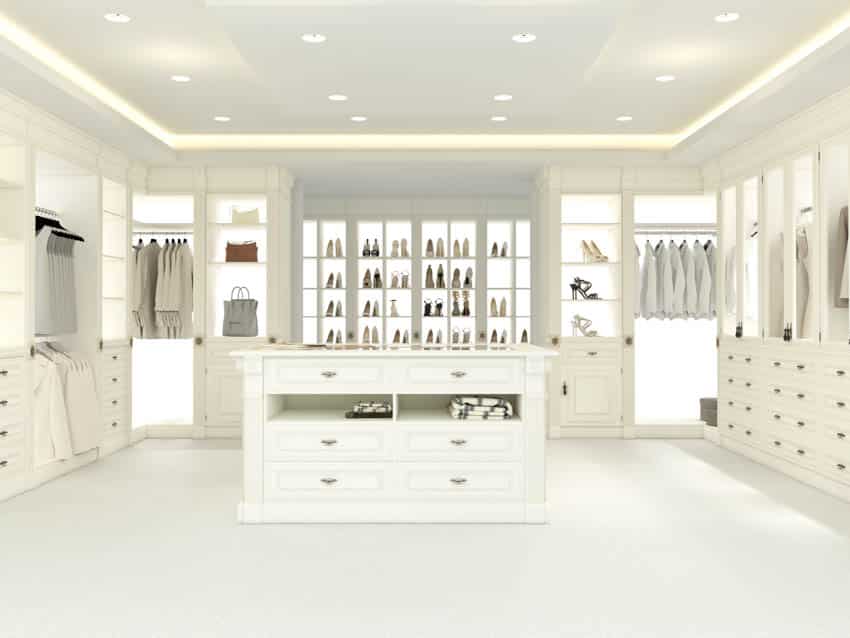 Spacious closet with lighted shoe racks and white flooring
