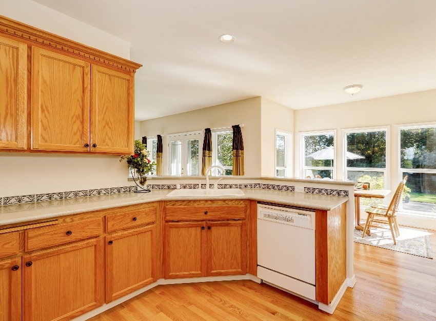 light brown kitchen cabinets and white appliances in the kitchen room