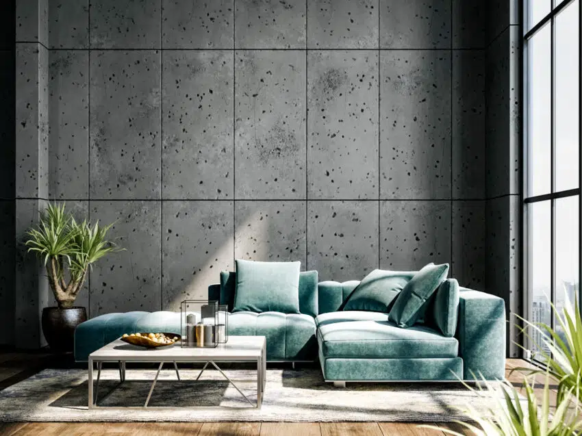 Living room with green couch large windows and concrete wall