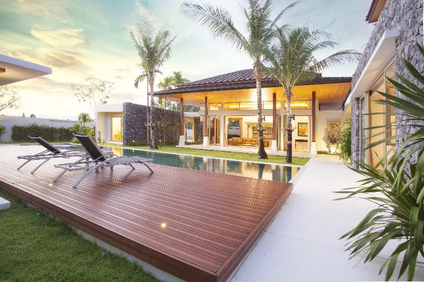 luxury tropical modern island home exterior with composite decking and swimming pool