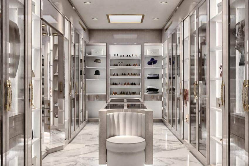 Luxury walk in closet design with sitting island and tile floor