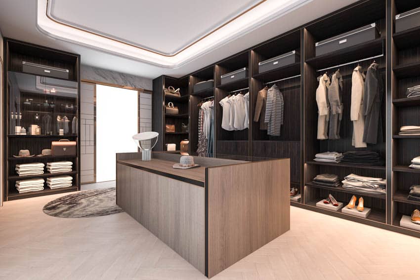 Masculine closet with wood veneer island and flooring