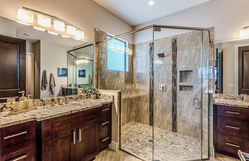 Master bathroom with river rock shower floor dual vanities granite countertops