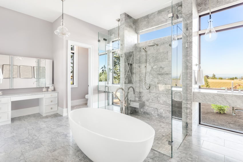 Modern bathroom with white bathtub shower and bench 