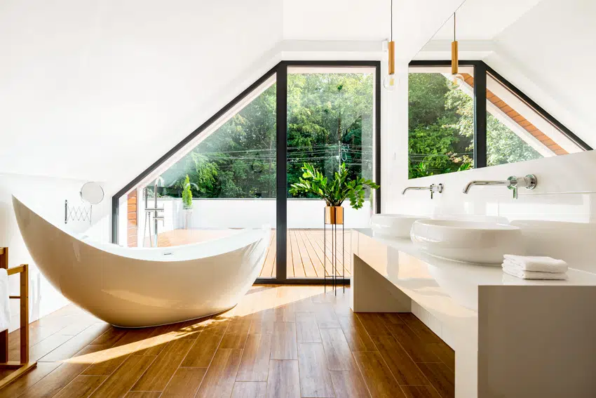 Modern bathroom with wood flooring bathtub and white sink