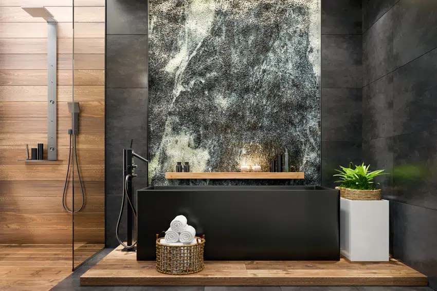 Modern bathroom with wood flooring in shower area and black bathtub