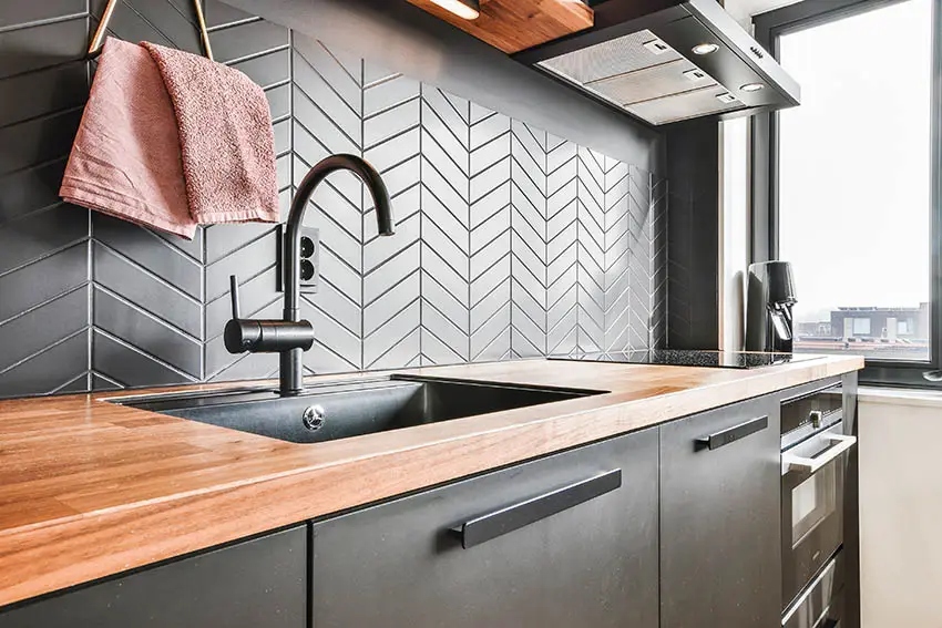 Butcher block kitchen countertops and modern tile backsplash