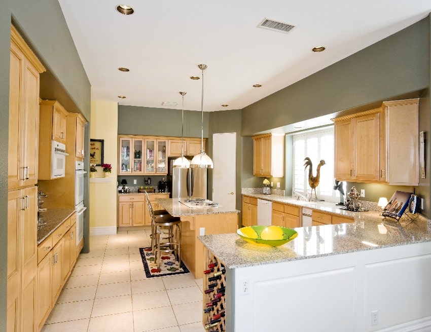 modern kitchen with gray wall paint oak cupboards and stools at the island