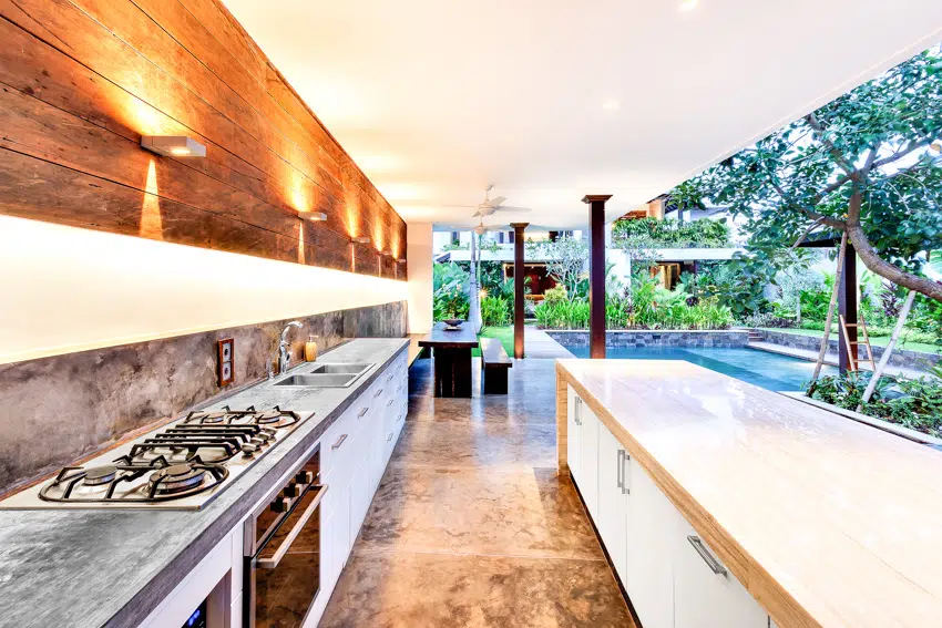Modern outdoor kitchen with stove countertop island and lighting