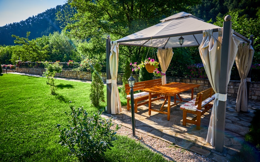 Outdoor pergola with light mounted on stands in garden