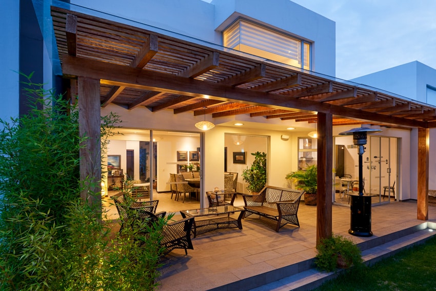 Patio pergola in backyard of home with hanging lights