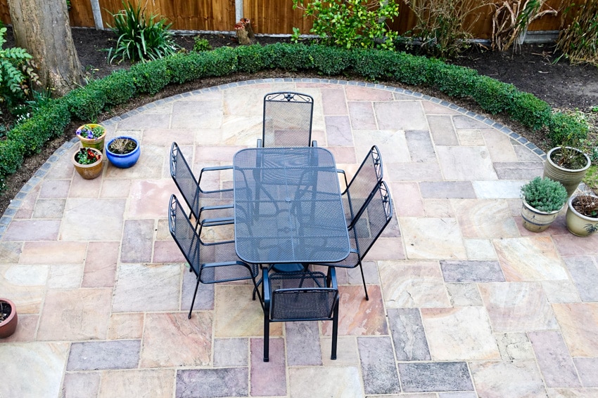 Powder coated table chairs outdoor on slate patio pavers