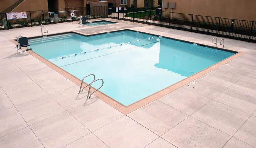 Public swimming pool with concrete salt finish deck