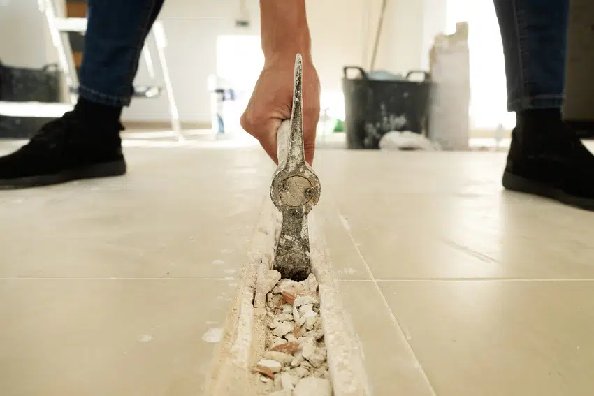 Removing tile flooring with hammer