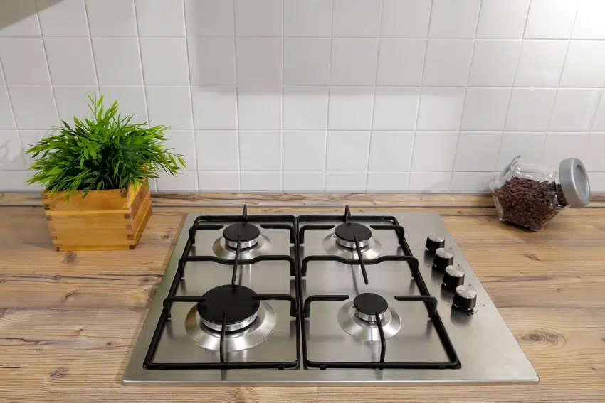 Silver gas stove on wooden kitchen surface