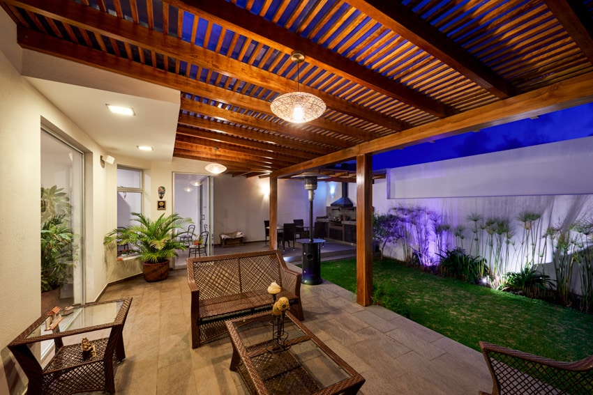 Slatted wood pergola shade in backyard patio