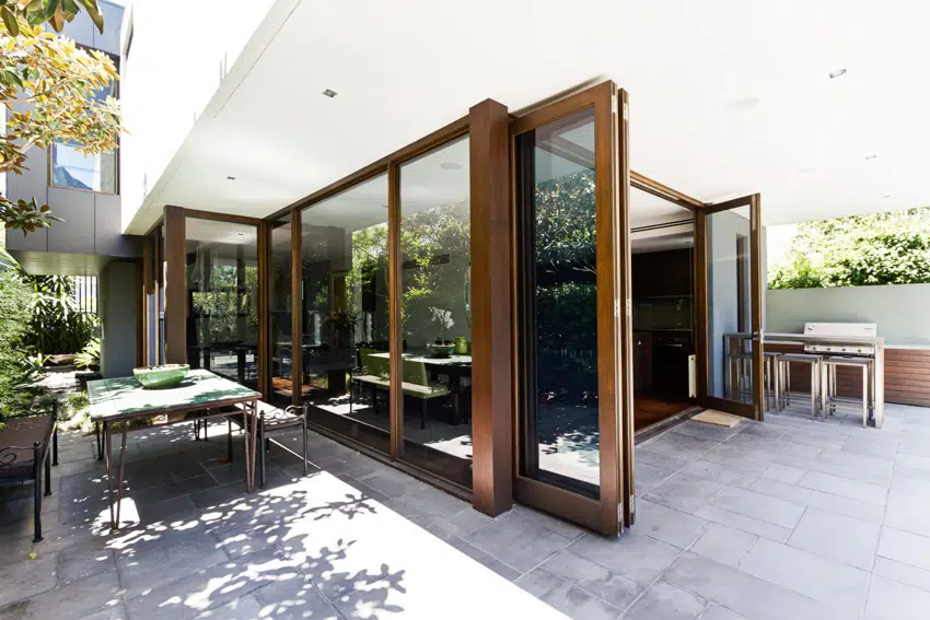 Sliding folding patio door with large windows and outdoor furniture