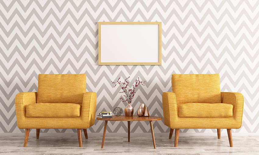 Striped wallpaper in living room with yellow arm chairs