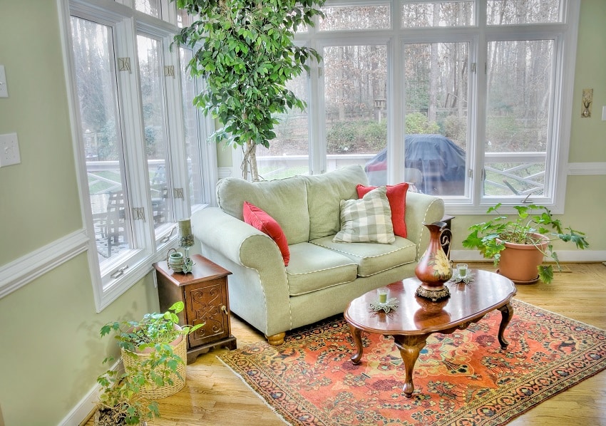 sunroom with plants and some antique furnitures