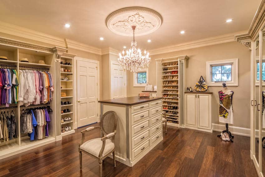 Closet center island, chandelier and wooden plank floor