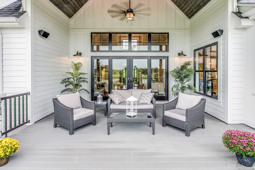 White house with folding patio door ceiling fan and outdoor furniture