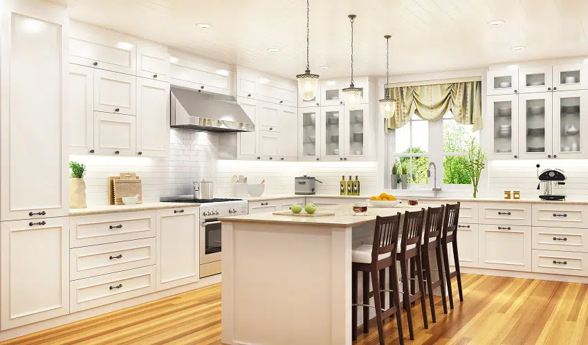 off white kitchen with cabinets wooden flooring white granite countertop island and brown chairs