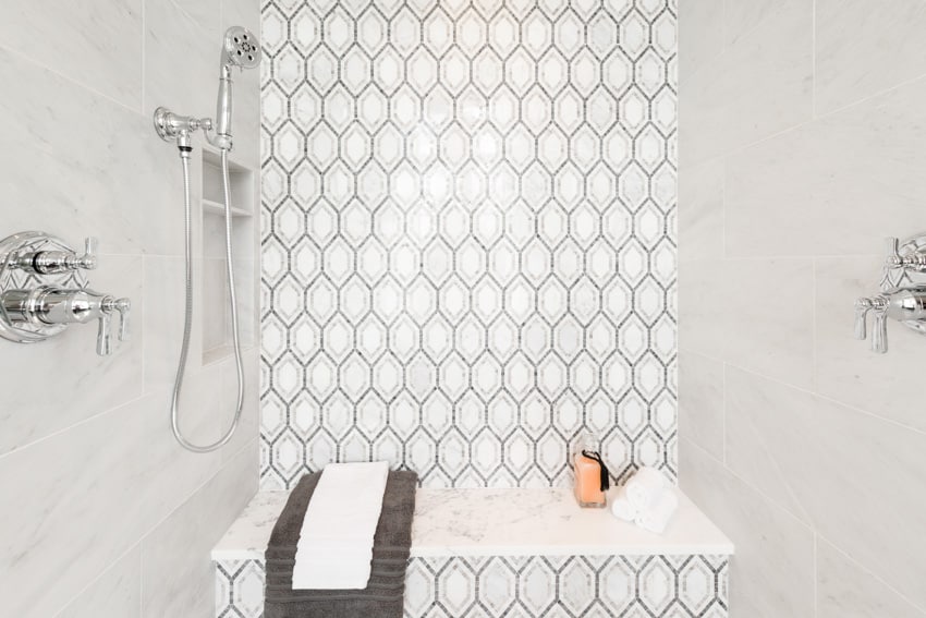 White room with shower bench and patterned wall