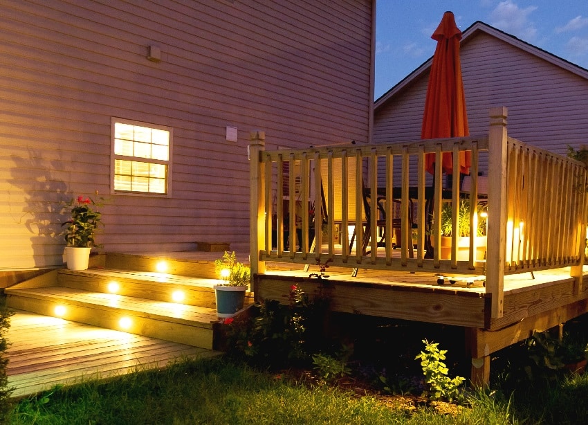 wooden deck and patio of family home at night
