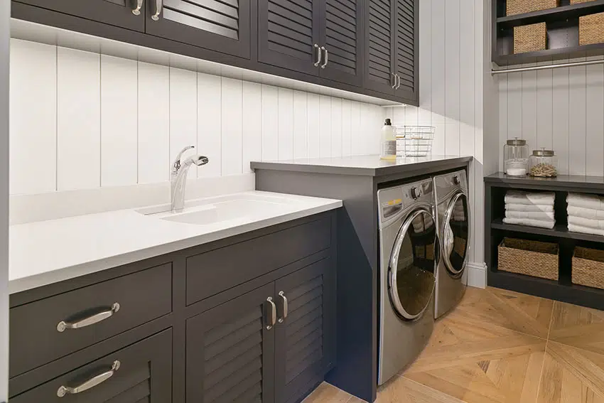 Laundry room with black cabinets small basin sink is