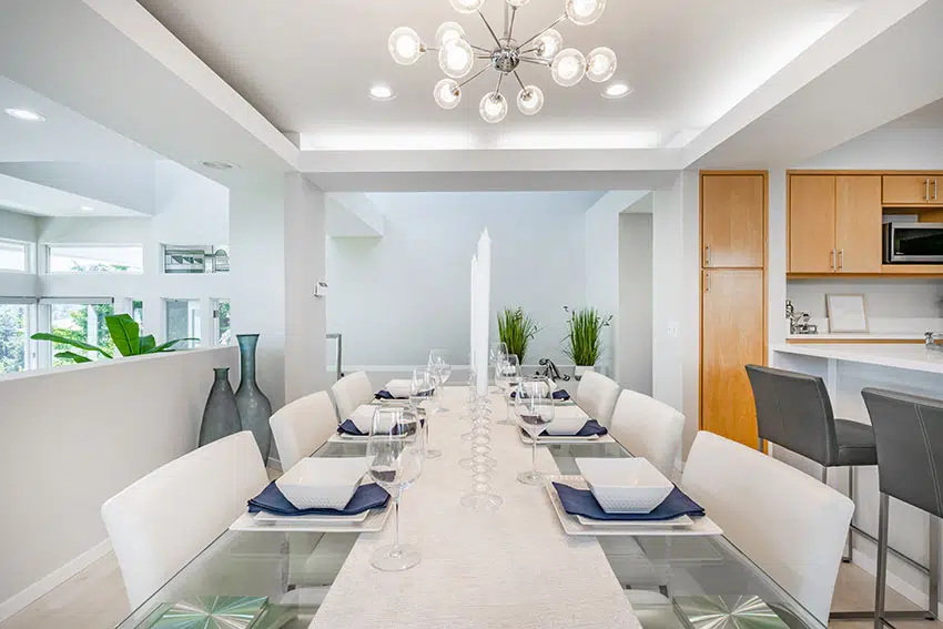 Modern dining area with glass table chandelier is