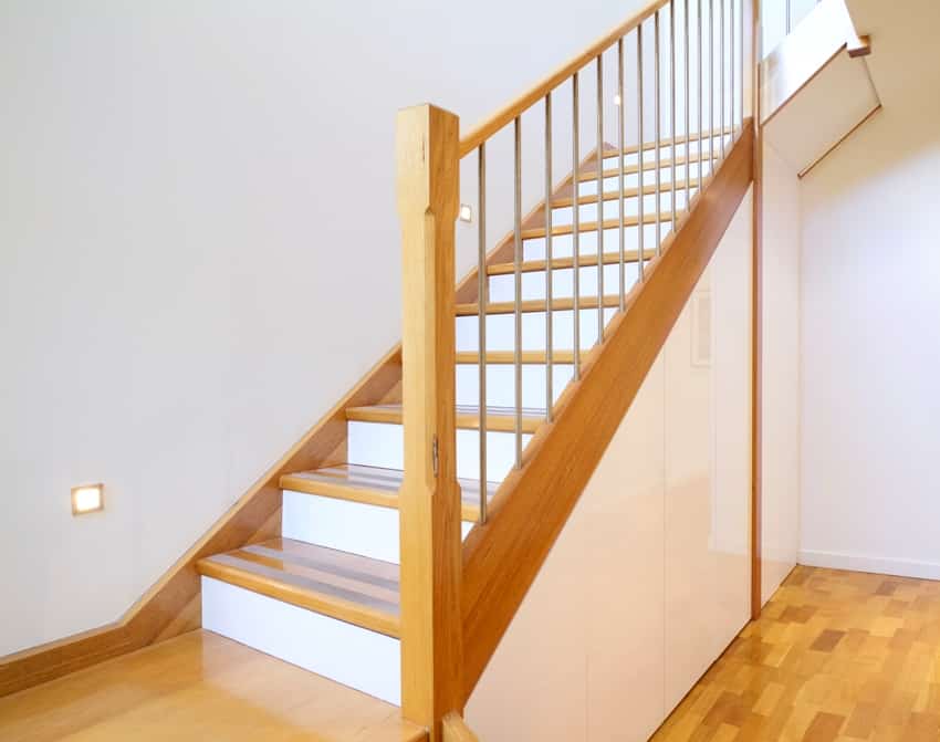 oak staircase with white wall and risers