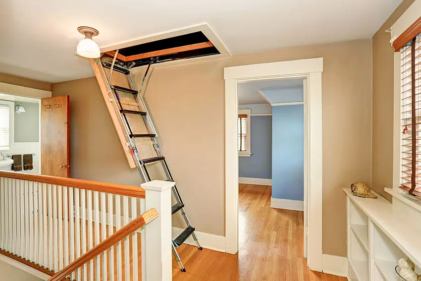 Staircase landing with ladder to scuttle attic beige paint blue room