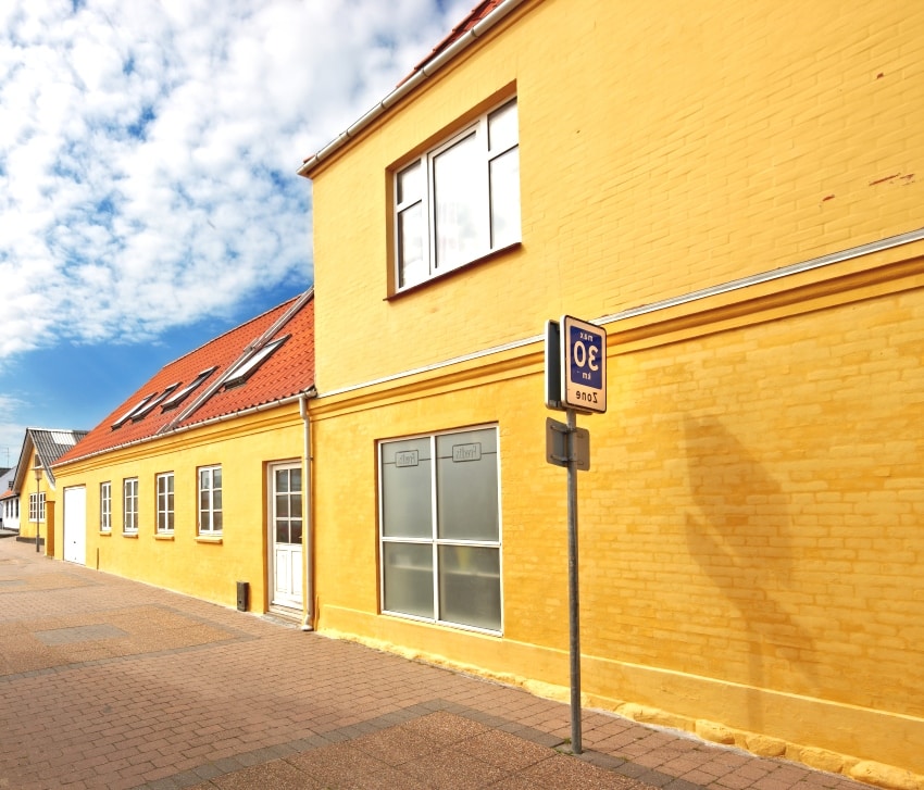 a street and old danish houses with midsummer gold paint