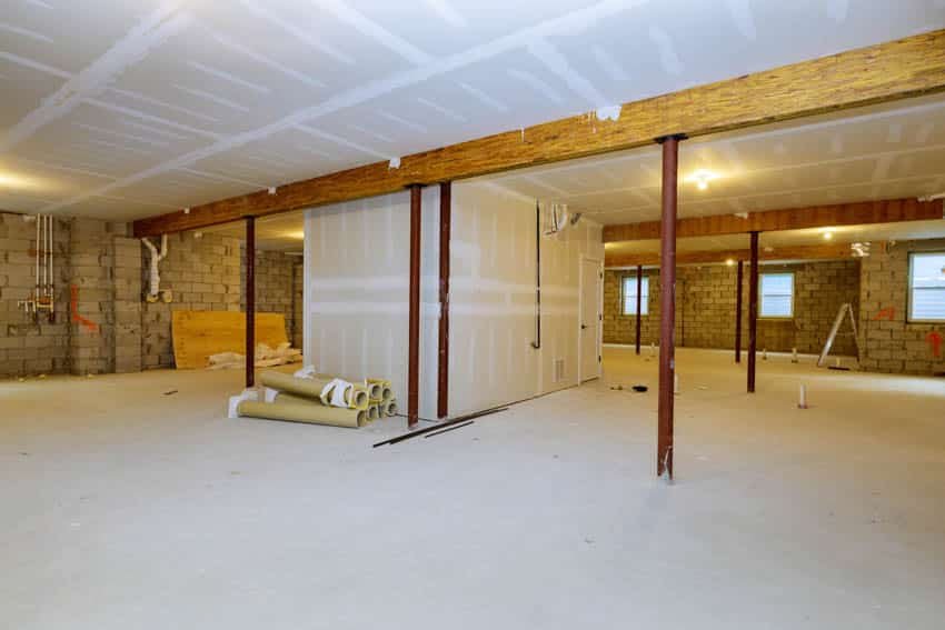 Basement with exposed ceiling and drywall