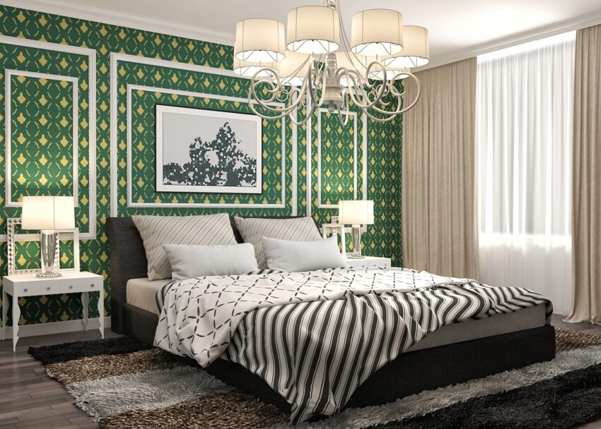 Beautiful bedroom with bed dark carpet, a green wall accent bedside table with lamp and nice chandelier