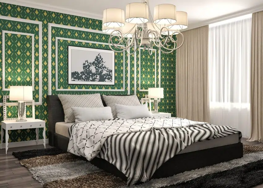 Beautiful bedroom with bed dark color carpet on the floor a green wall accent bedside table with lamp and nice chandelier