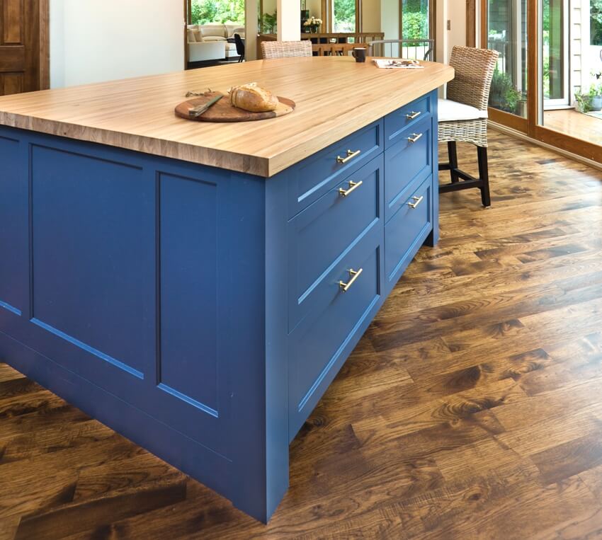 Beautiful kitchen with blue island trim and hard wood flooring