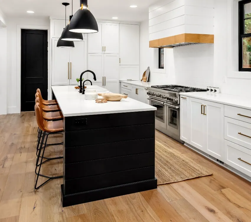Beautiful white kitchen with black kitchen island trim and dark accents