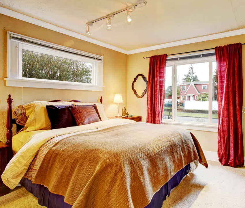 Bedroom in dark beige tone with maroon curtains