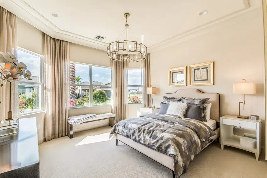 Bedroom with chandelier big windows and gold decor