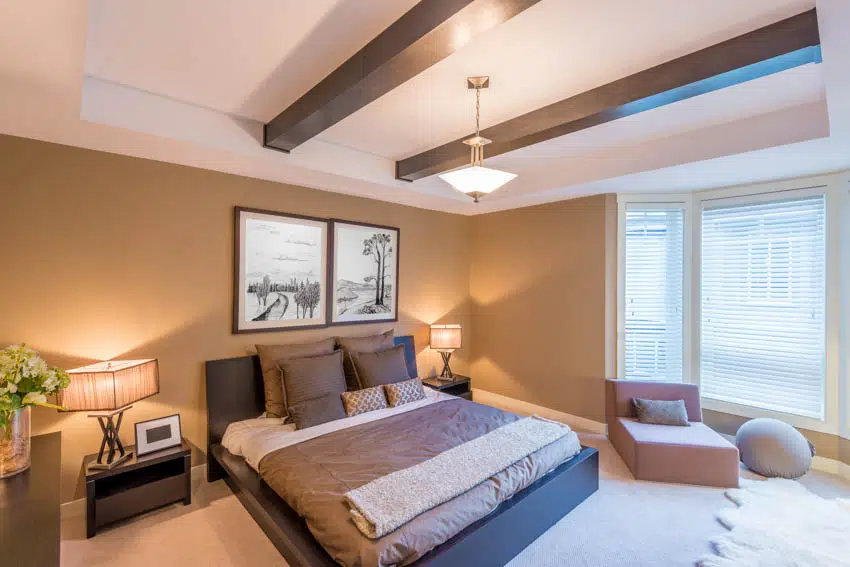 Bedroom with gold accents and coffered ceiling 