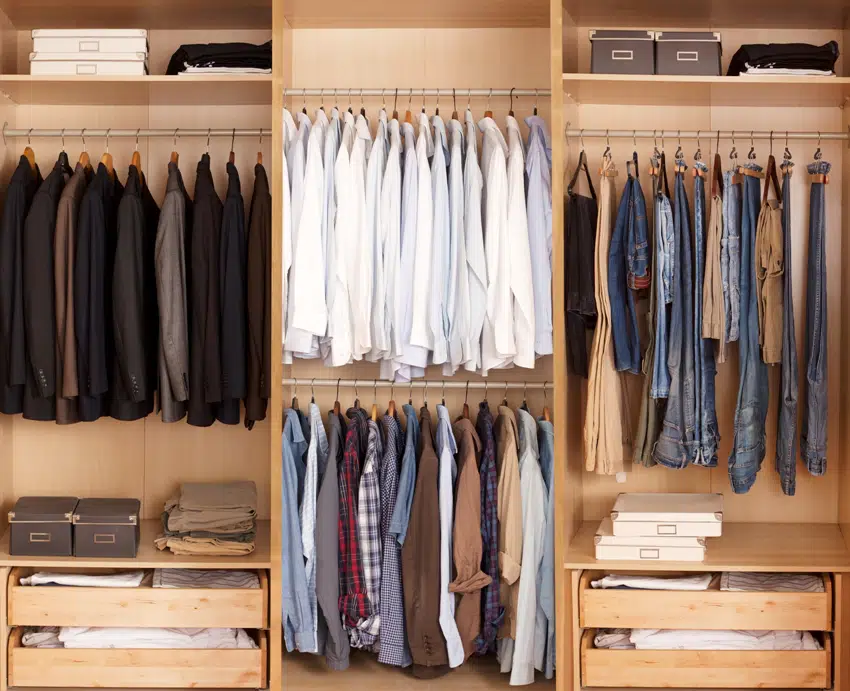 Big wardrobe with color coded organization of male clothes